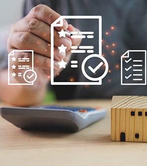 A person digitally signing a contract with house models, highlighting real estate investment, property evaluation, and agreement approval.