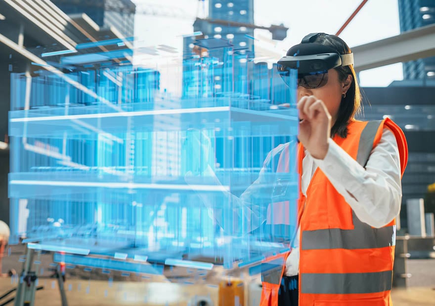 Japanese Female Architect Wearing an Augmented Reality Headset and Inspecting a Digital Hologram of a Building. Asian Civil Engineer Using a Software with Virtual Construction Plan and Interior Model