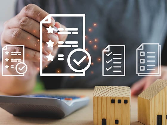 A person digitally signing a contract with house models, highlighting real estate investment, property evaluation, and agreement approval.