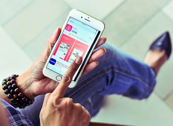 BANGKOK,THAILAND SEPTEMBER 2,2017 : Woman Using Airbnb Apps to Discover entire homes and private rooms perfect for any trip.Influencer millennial Using Social Media on Smartphone, Like, Follower.